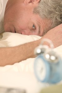 Man Waking to Alarm Clock